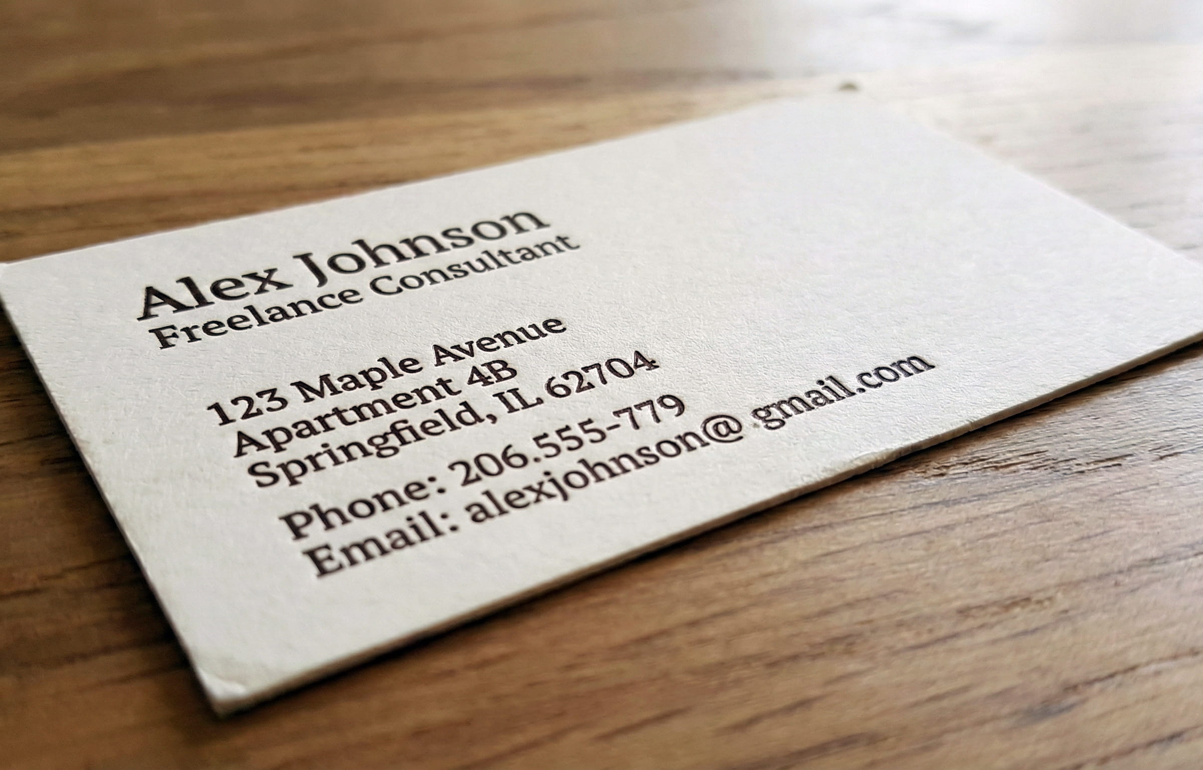 a weathered business card with an obvious residential address